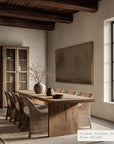 dining room with wooden table and chairs, framed artwork on the wall.
