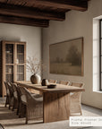 dining room with wooden table and chairs, framed artwork on the wall.
