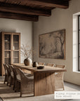 dining room with wooden table and chairs, framed artwork on the wall.