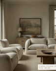 living room with beige sofa, armchairs, and a wooden coffee table.