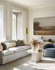 modern living room with a gray sofa, round coffee table, and wall art.