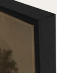 close-up of a black framed artwork with a textured beige background