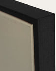 close-up of a black frame corner with a neutral background