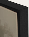 close-up of a black frame corner with a textured beige surface.