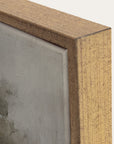 close-up of a wooden frame corner with a textured gray surface inside