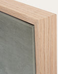 close-up of a wooden frame corner with a gray background