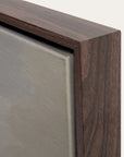 close-up of a wooden picture frame corner with a neutral background