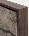 close-up of a wooden frame with a textured wall art piece inside
