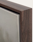 close-up of a wooden picture frame corner with a neutral background.