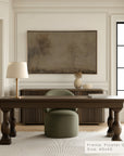 modern office interior with a wooden desk, chair, and framed artwork on the wall.