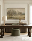 decorative painting of a landscape with trees and sheep on a wall above a wooden desk.