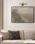 forgotten road in a black floater frame under a brass picture light, above a cream sofa with striped and black patterned pillows. shown in floater black, 40 x 30.