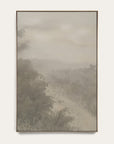 forgotten road vertical art print in a gold floater frame. a foggy road fades past a dark stand of trees in soft grays and warm stone tones, shown against a plain off-white wall.