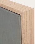 close-up of a wooden frame corner with a gray background