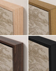 four square close-up views of framed wall art showing different wood and black frame finishes against a light beige patterned paper background.