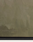 textured green surface with a signature at the bottom right corner