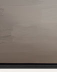 textured beige wall with a black baseboard