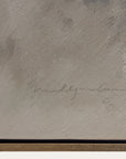 textured beige surface with a signature and black border