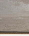 textured beige surface with a signature at the bottom
