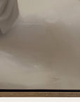 close-up of a beige fabric surface with a brand logo.