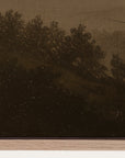 sepia-toned landscape with trees and a field, possibly from an old photograph or painting.