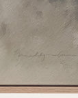 textured beige surface with a signature and wooden base