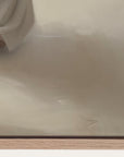 close-up of a beige fabric with a brand name on a wooden surface.