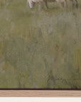 close-up of a textured green painting with a signature at the bottom right corner.