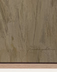 close-up of a textured brown surface with a signature at the bottom right corner.