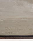 textured beige surface with a signature at the bottom