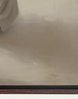close-up of beige fabric with a brand name on a wooden surface.