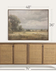 wooden sideboard with wicker doors and framed landscape painting above it, showing dimensions.