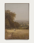 framed painting of a landscape with a person walking on a path through a field.