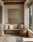 nook with a wooden bench, pillows, and a woven basket by a window.