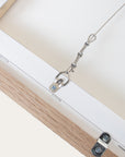 close-up of a wooden frame with a metal hanging hook on a white background