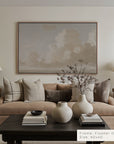 living room with beige sofa, decorative pillows, and a coffee table with vases.