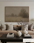 living room with a beige sofa, wooden coffee table, and framed landscape art on the wall.