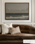 brown sofa with decorative pillows in a room with a framed landscape painting on the wall.