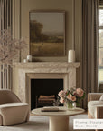 living room with marble fireplace, armchair, and floral arrangement.