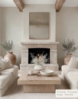 living room with a fireplace, white sofas, and decorative elements.