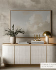 modern interior with a sideboard, lamp, and framed artwork on a textured wall.