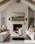 living room with stone fireplace, white sofas, and a painting above the fireplace.