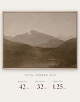 white mountains in a light oak floater frame with its total framed size listed below: 42 inches wide, 32 inches high, and 1.25 inches deep.