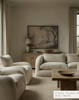 living room with beige sofa, armchairs, and wooden coffee table.