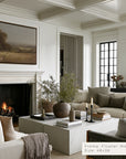 cozy living room with fireplace, sofa, and decorative elements.