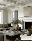 living room with a fireplace, sofa, coffee table, and decorative items. 