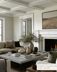 living room with a fireplace, sofa, coffee table, and decorative items.