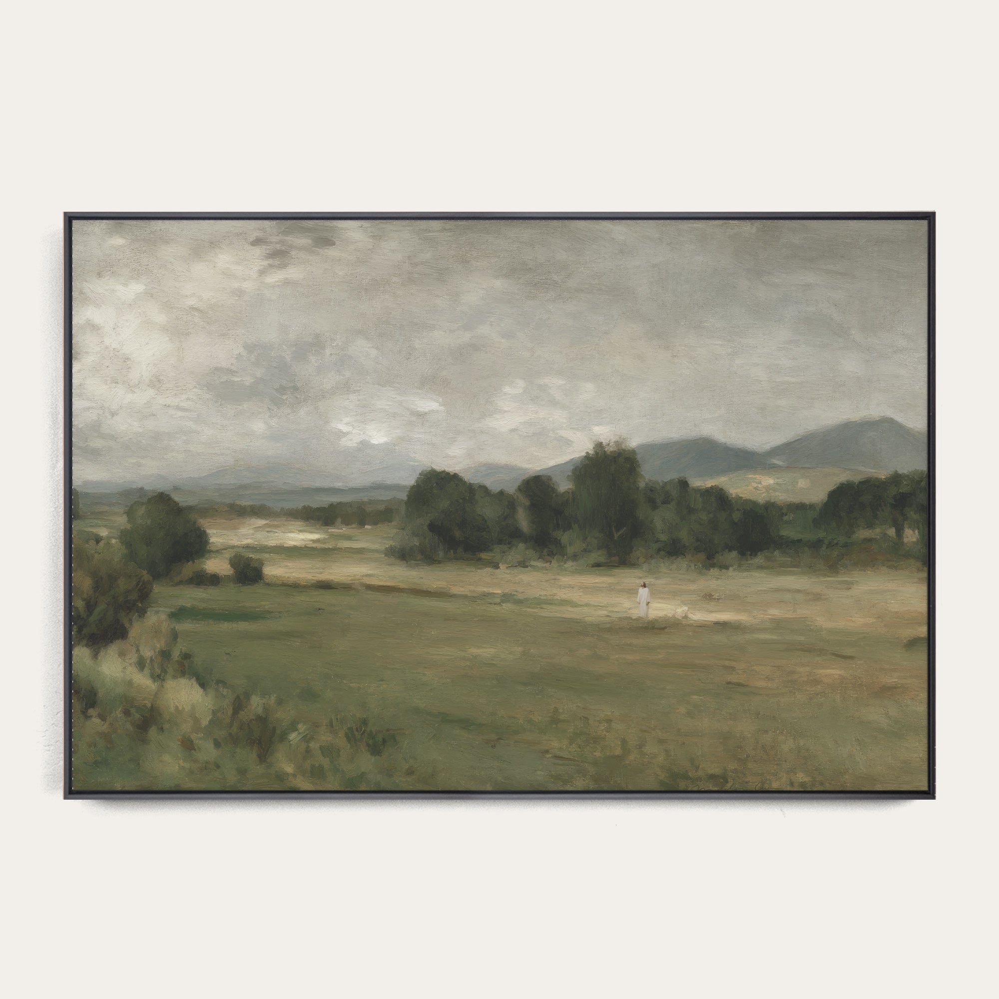 Framed painting of a landscape with a figure walking on a path. 