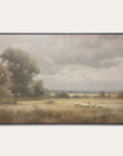 framed landscape painting of a field with sheep and trees on a white wall. 