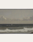 framed artwork of a coastal scene with waves and a distant figure on a beach. 